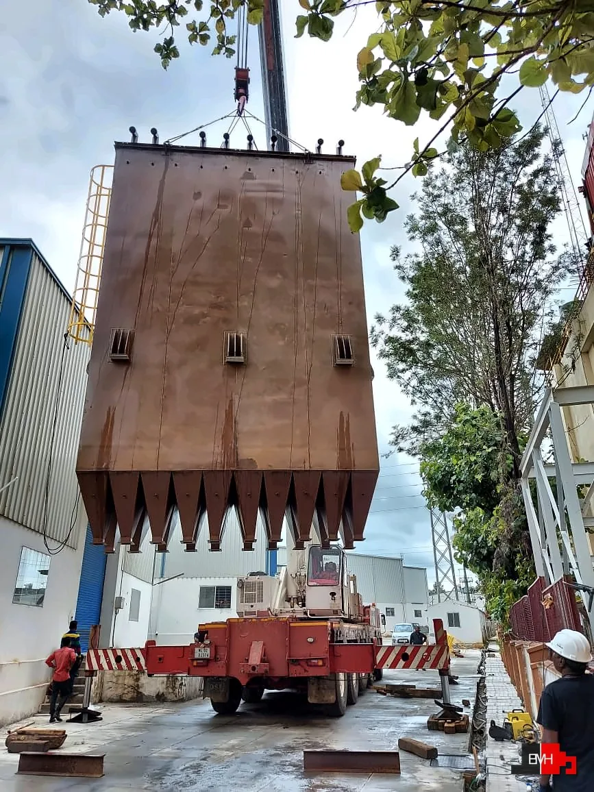 Ten-compartment green coffee bean silo by Scorpio being lifted into place by crane